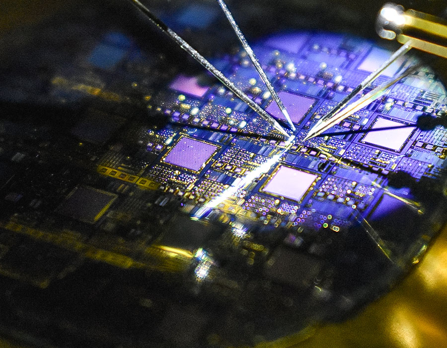four small probes measuring a silicon wafer
