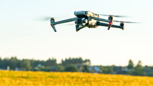 A drone hovering above a field